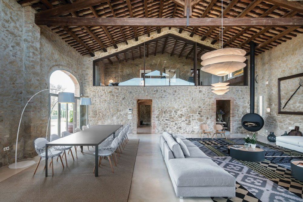 salotto di casa con pareti in pietra e soffitto a travi