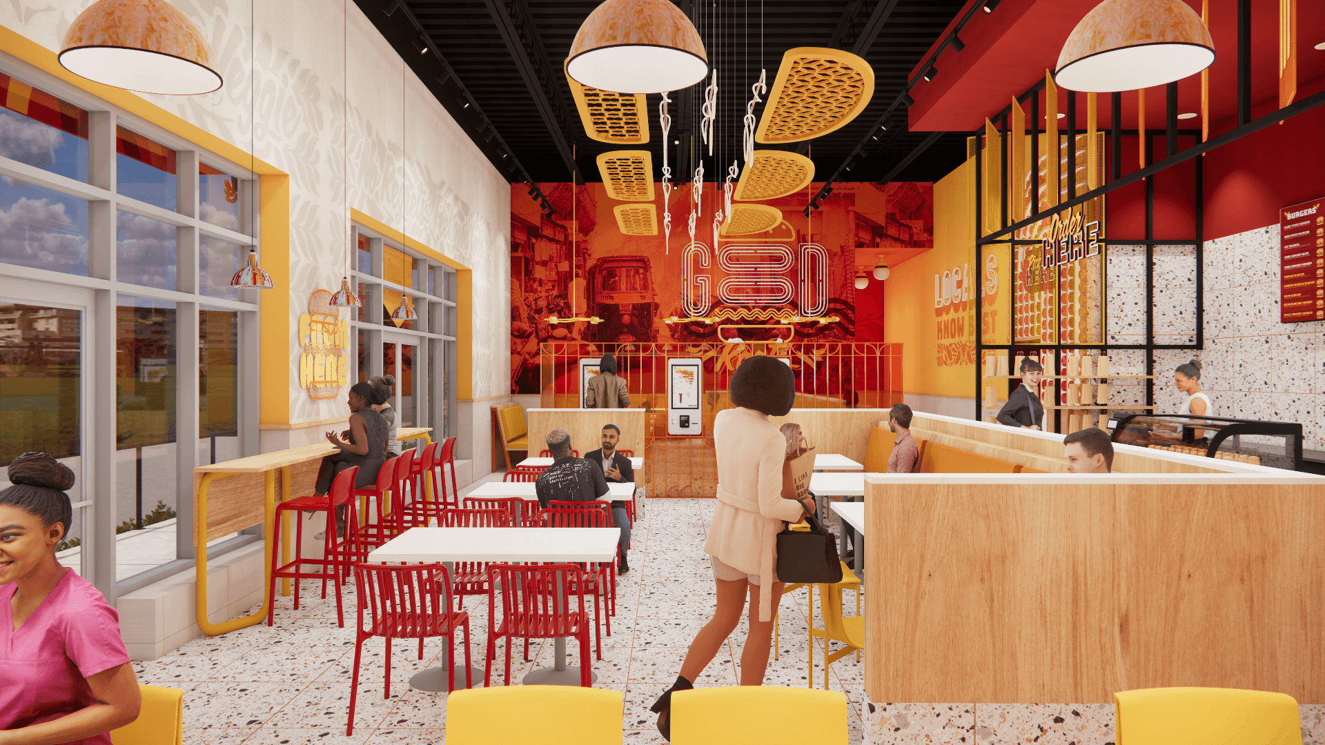 Interior of a colorful restaurant with customers seated at tables; red chairs, wood accents, and hanging lights.