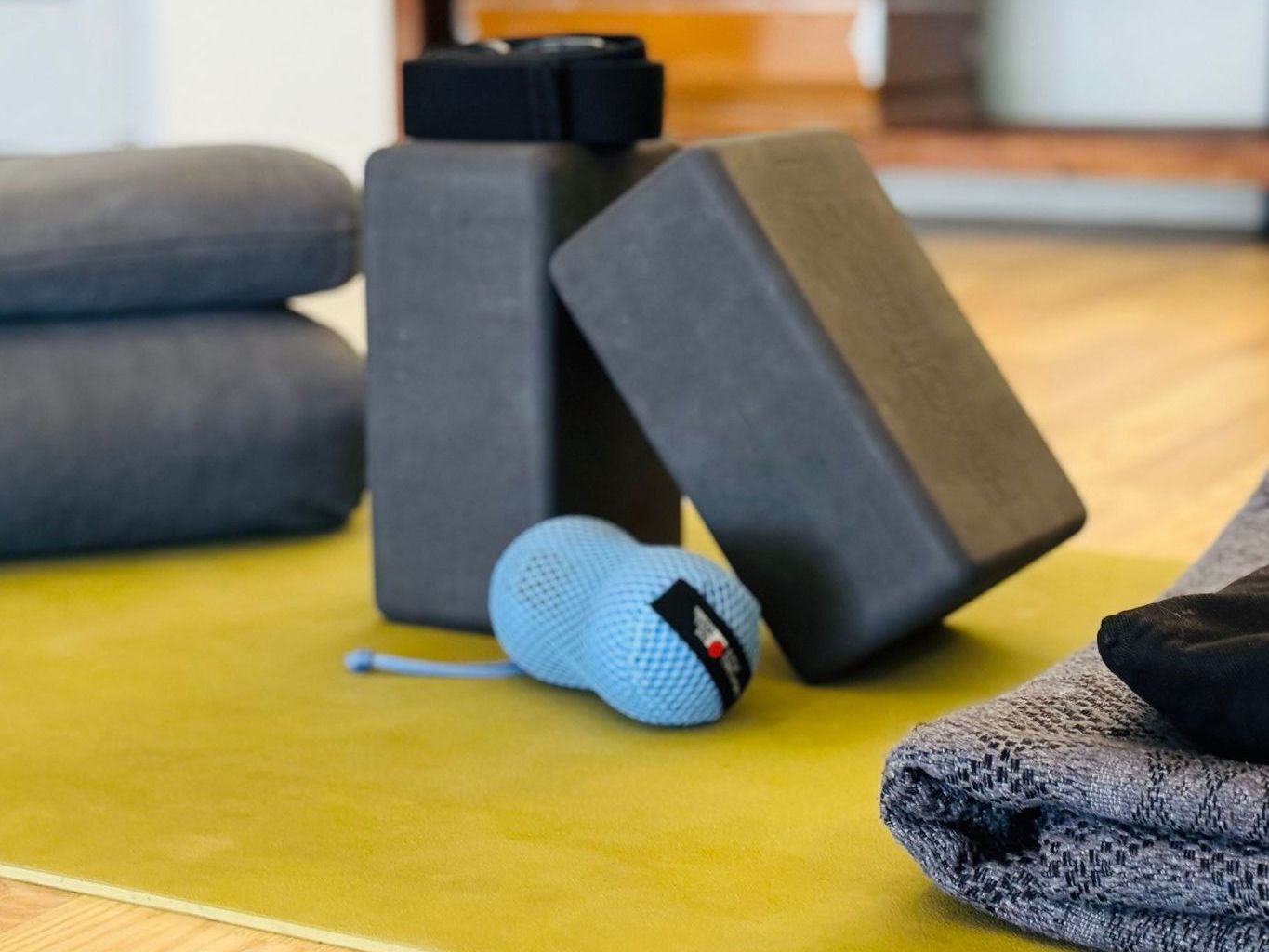 A yoga mat with blocks and towels on it