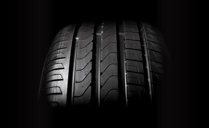 two black tires with silver rims on a white background