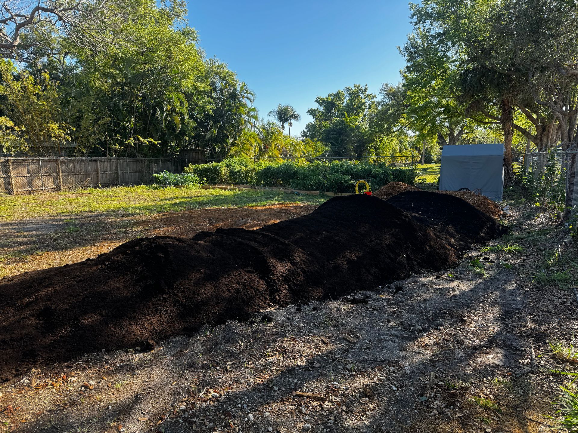 A pile of dirt is sitting in the middle of a field.