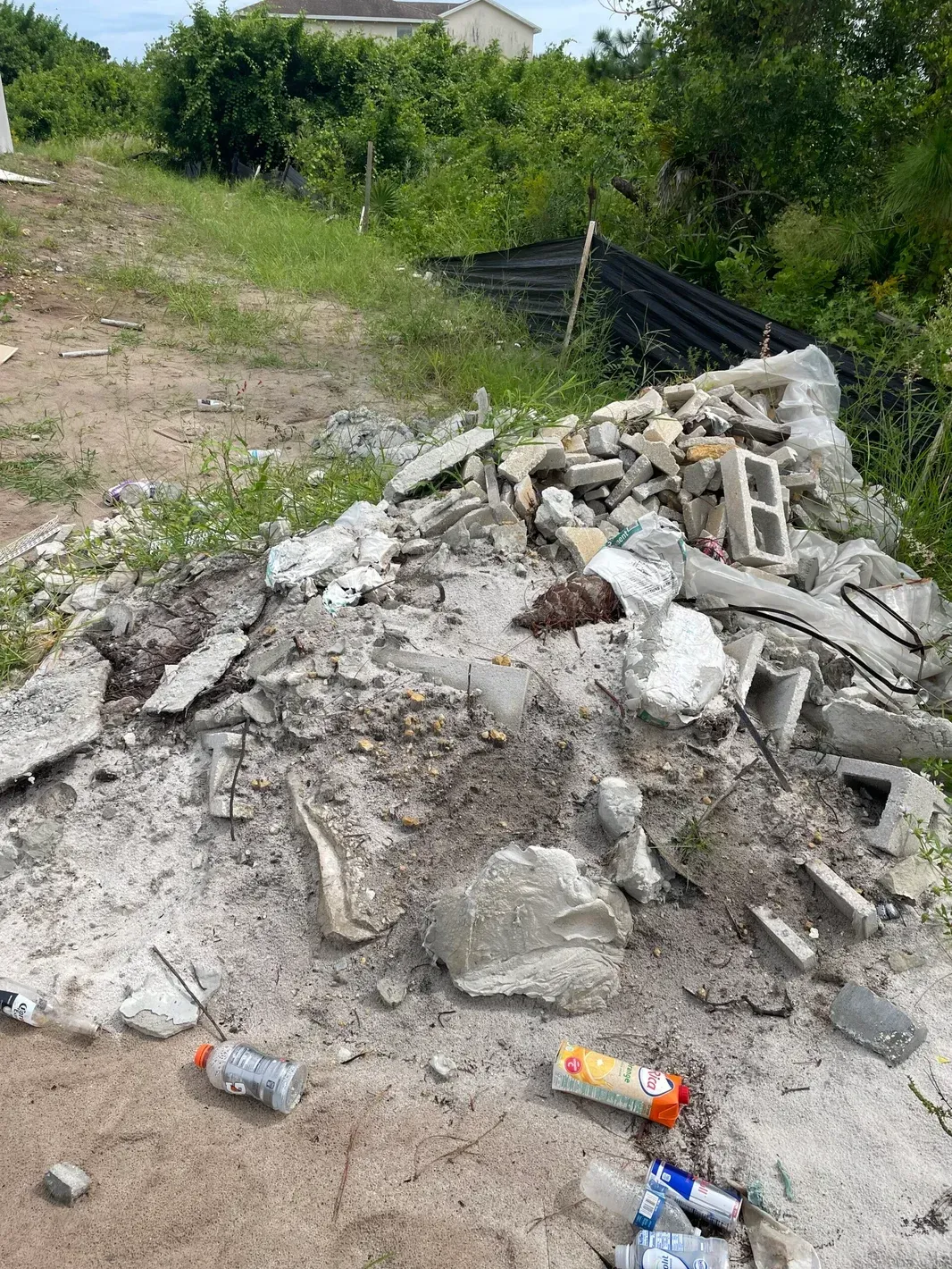 A pile of rubble is sitting on the ground in a field.