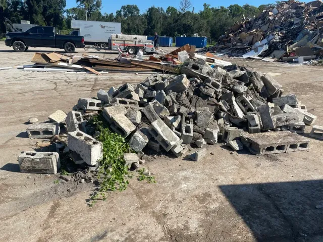A pile of concrete blocks is sitting in the middle of a dirt field.