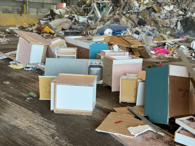 A bunch of broken pieces of furniture are sitting on the ground