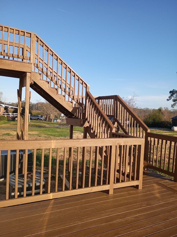 Wooden playground stairs and railings on a sunny day under a clear blue sky