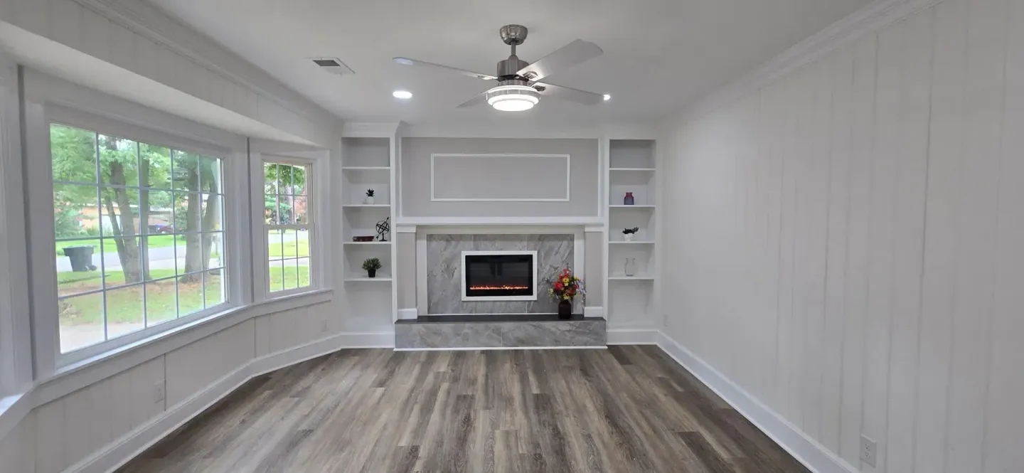 fireplace bay window built-in bookshelves laminate flooring 