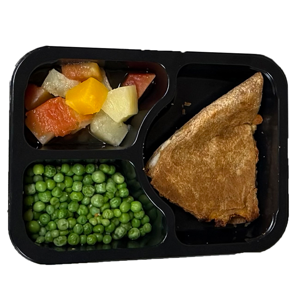 A tray of food with a slice of pie and peas