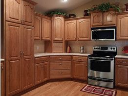A kitchen with stainless steel appliances and wooden cabinets
