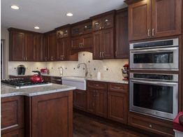 A kitchen with wooden cabinets and stainless steel appliances.