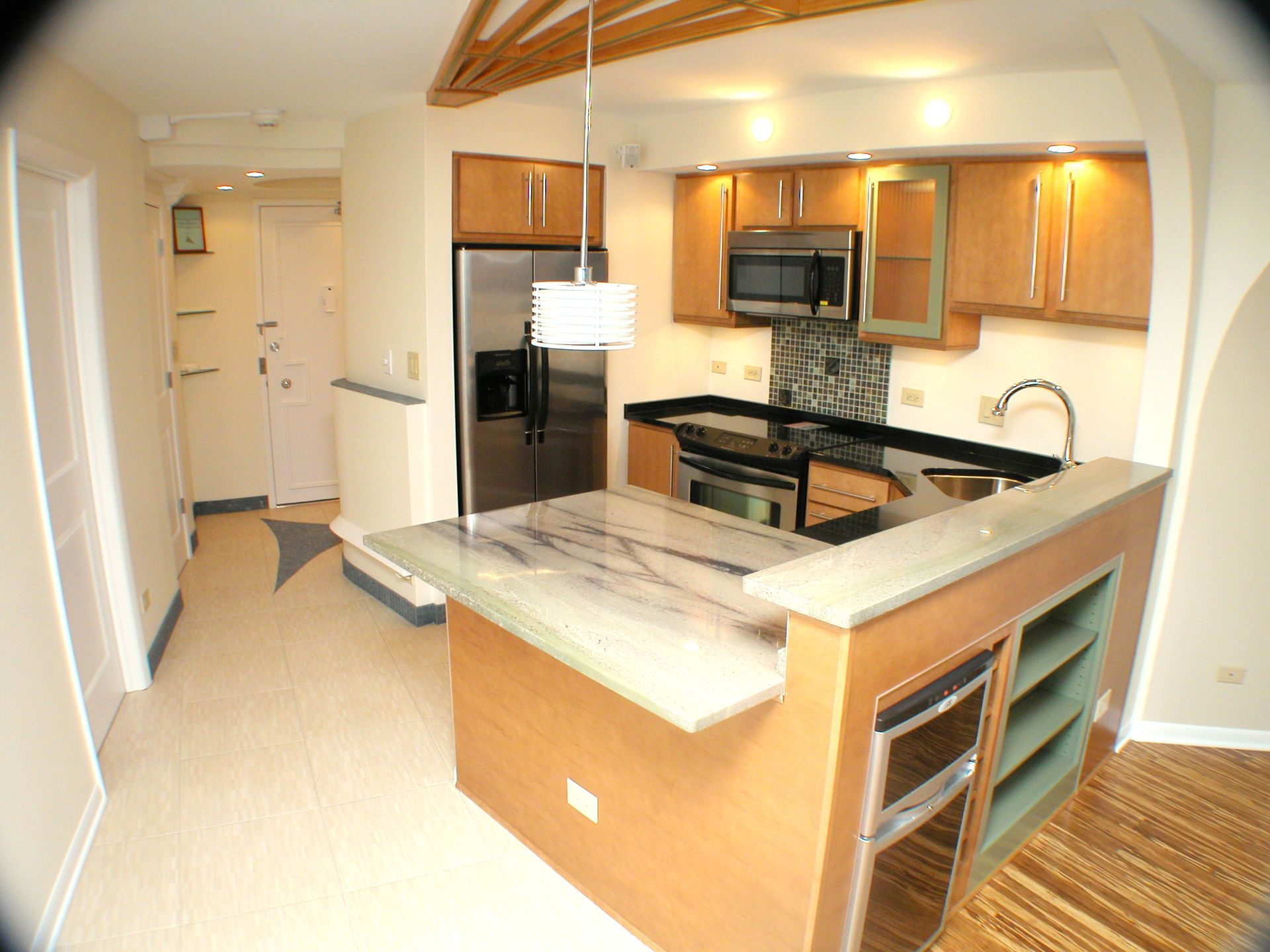 A kitchen with stainless steel appliances and wooden cabinets