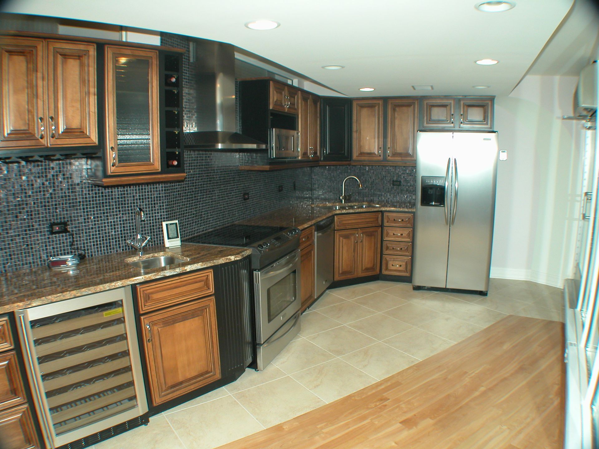 A kitchen with stainless steel appliances and wooden cabinets