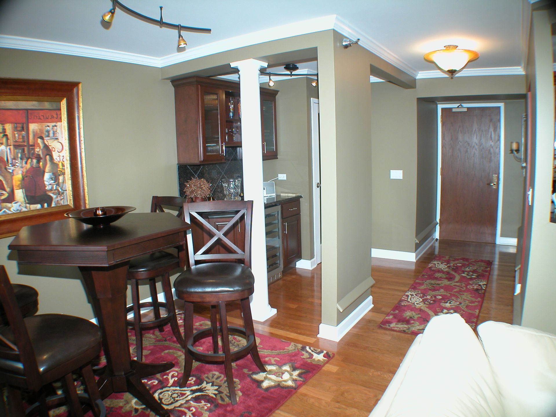 A living room with a table and chairs in it