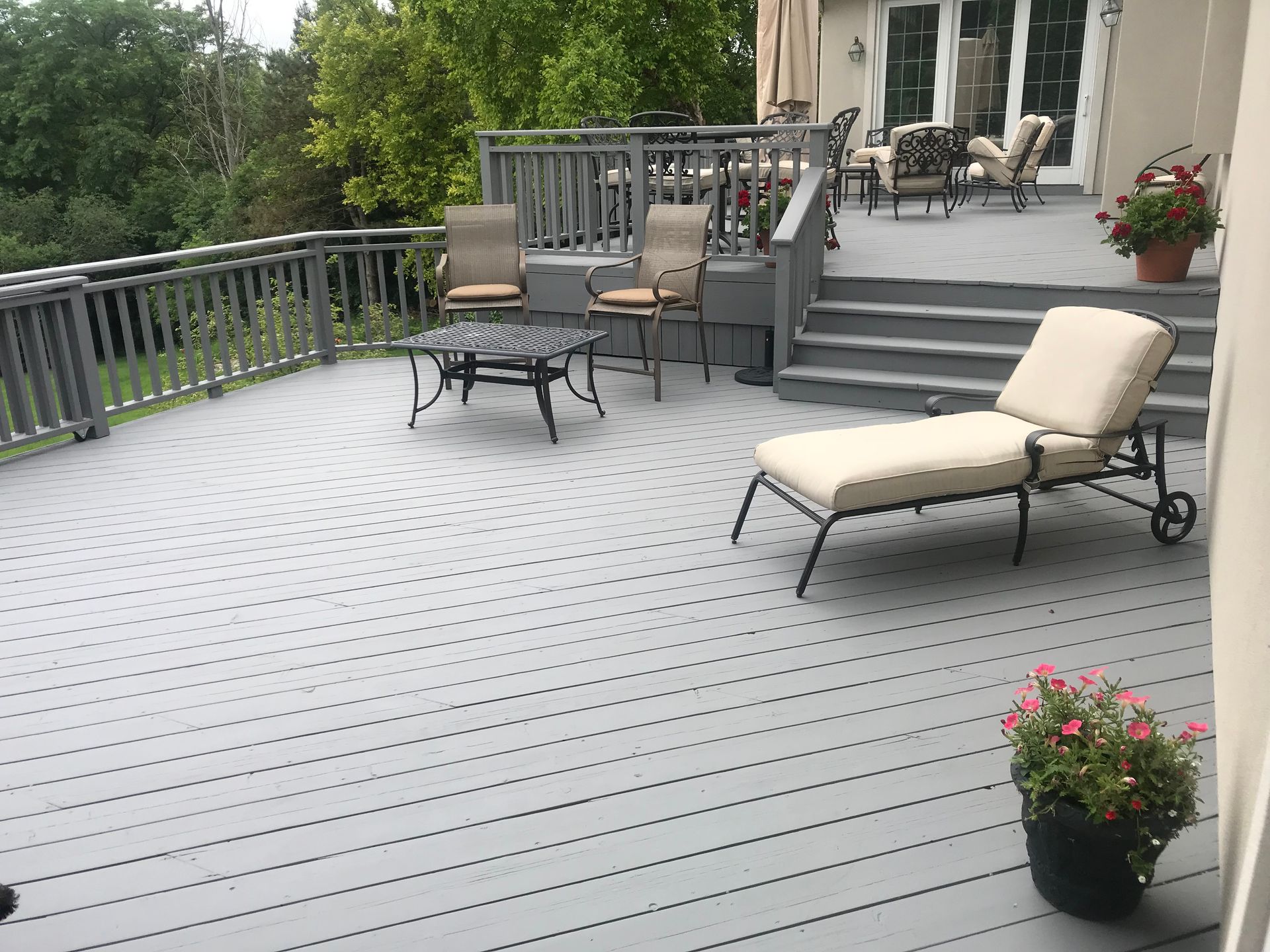 A large deck with a table and chairs on it