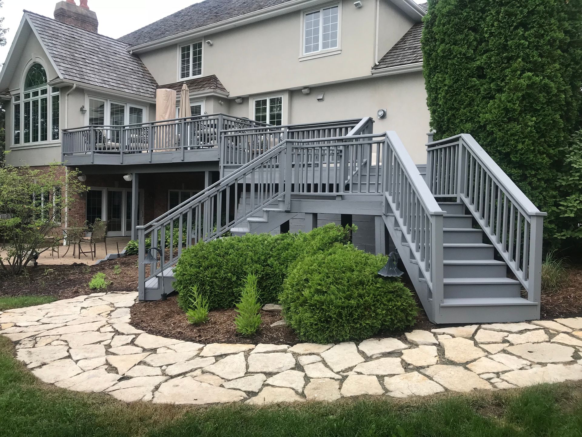 A large house with a large deck and stairs