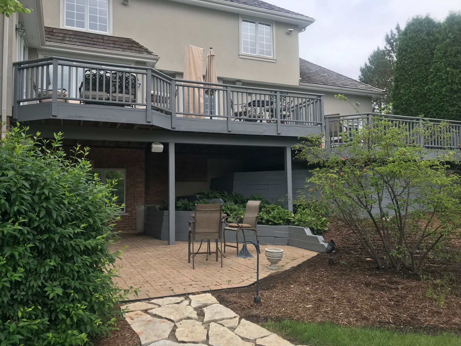 A large house with a large deck and patio area