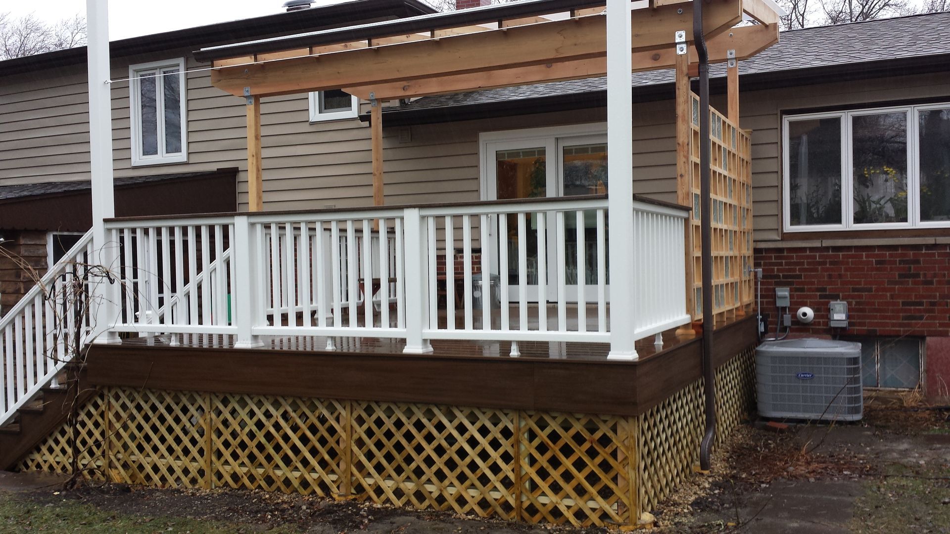 A house with a deck and stairs in front of it