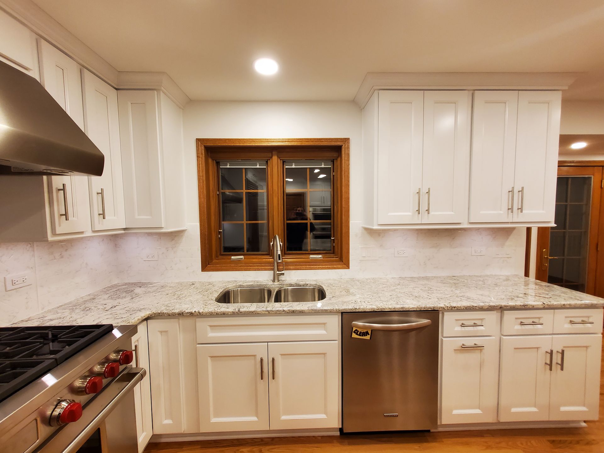 A kitchen with white cabinets and stainless steel appliances