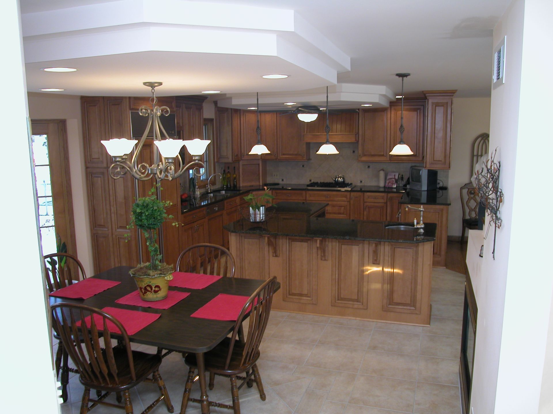 A kitchen with a table and chairs and a chandelier