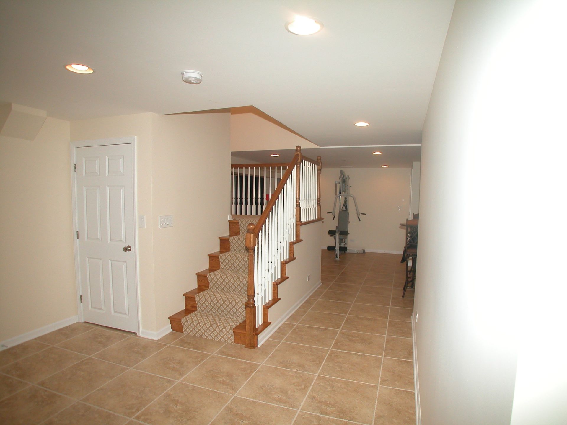 A hallway with stairs leading up to the second floor