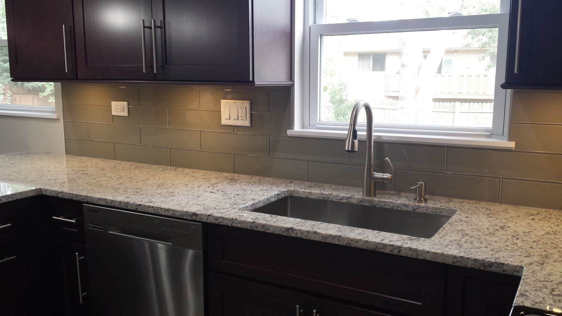 A kitchen with granite counter tops and stainless steel appliances