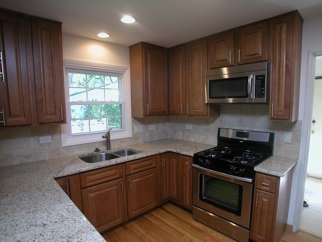 A kitchen with stainless steel appliances and wooden cabinets