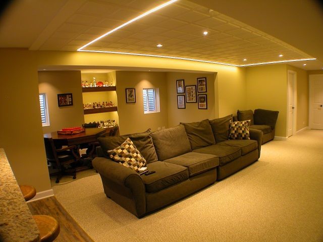 A living room with a large couch and a desk