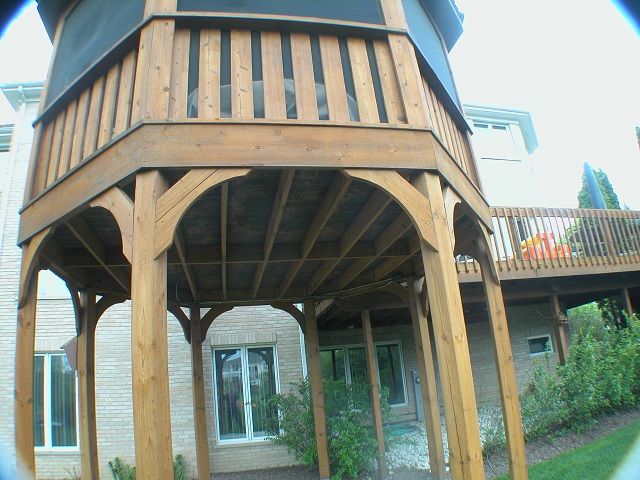 A house with a large wooden deck in front of it