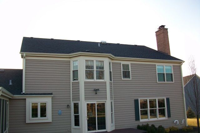 A large house with a lot of windows and a chimney