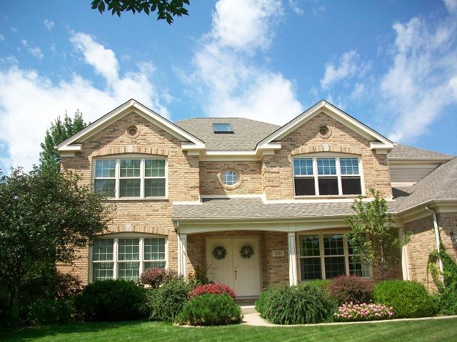 A large brick house with a skylight on the roof