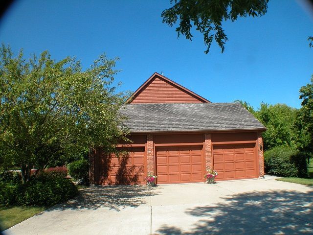 A large red garage with a gray roof