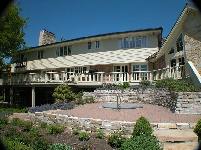 A large house with a large deck and stairs