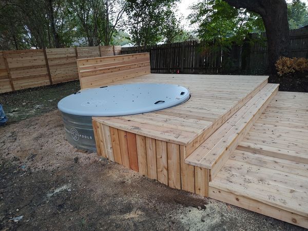 A wooden deck with a hot tub on top of it