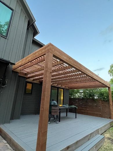 A House With a Wooden Pergola Over a Deck