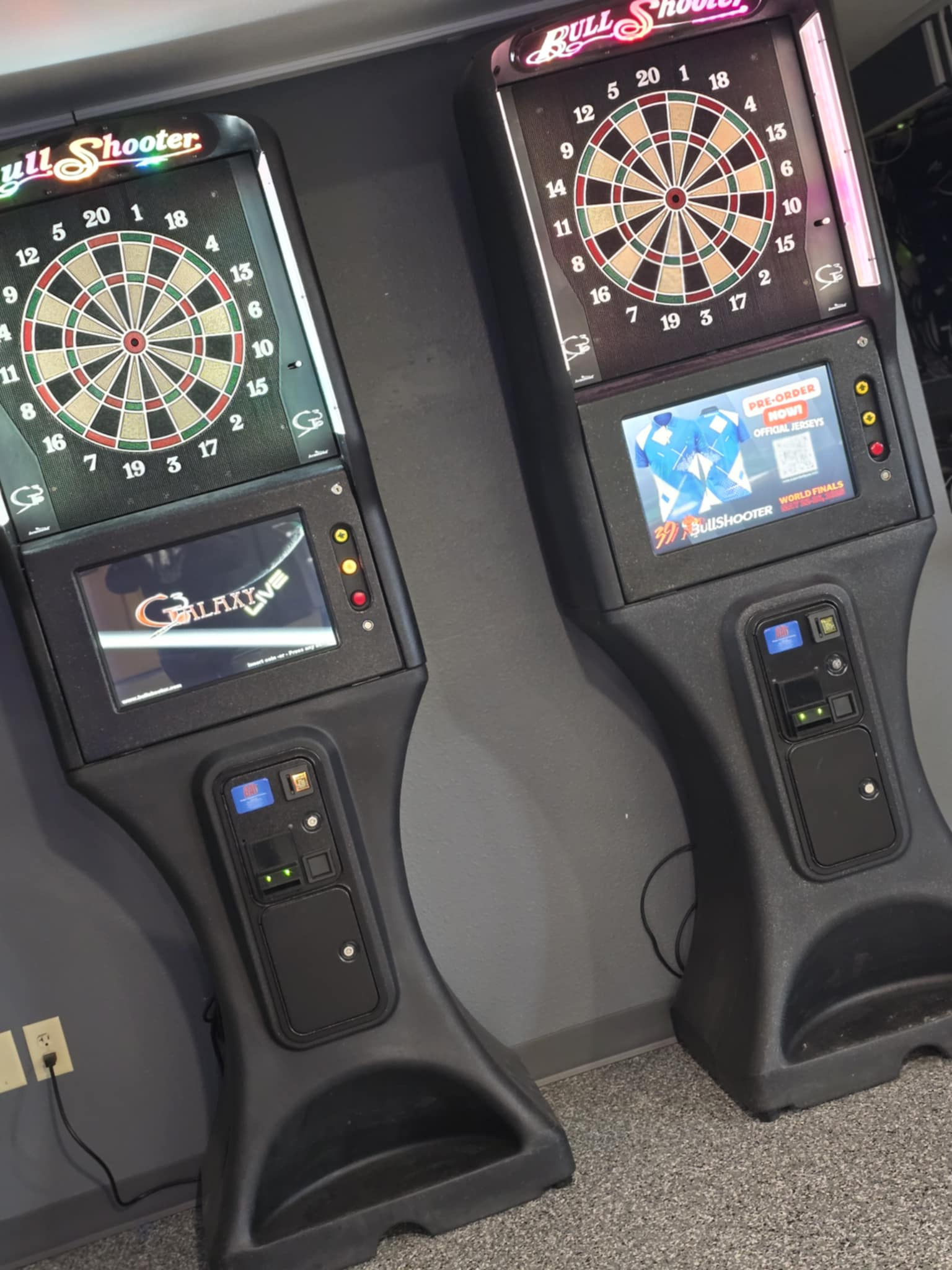 Two dart boards are sitting next to each other on the floor