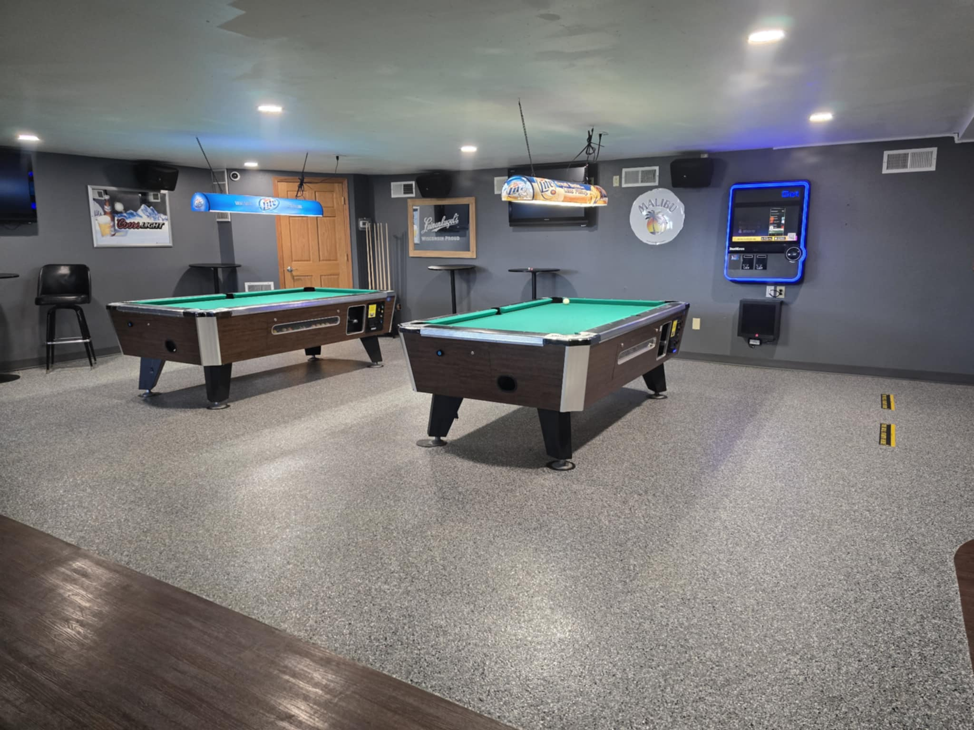 There are two pool tables in the room.
