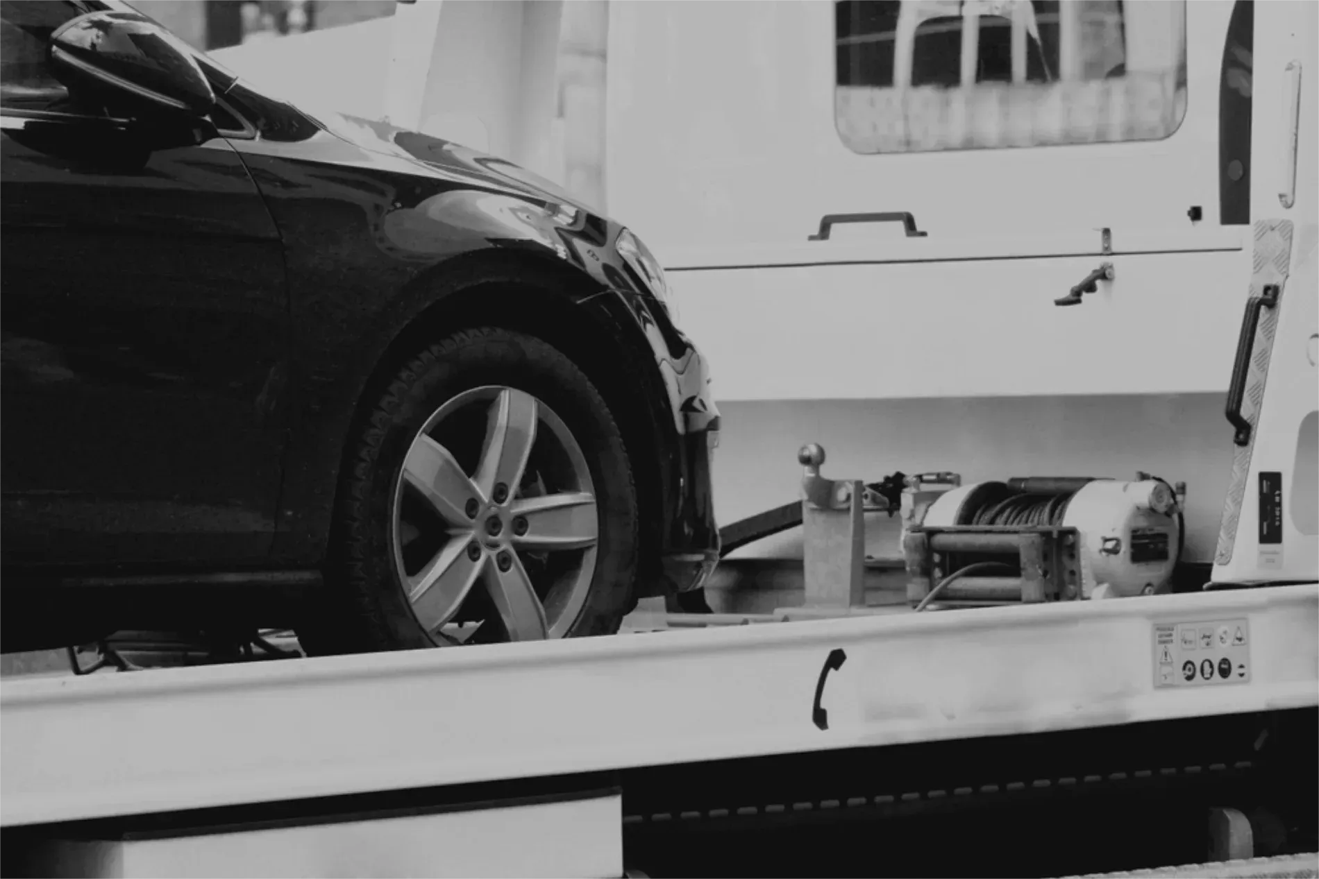 A Dark Car Sits Secured on the Flatbed of a White Tow Truck — JP's Towing and Transport in Esk, QLD