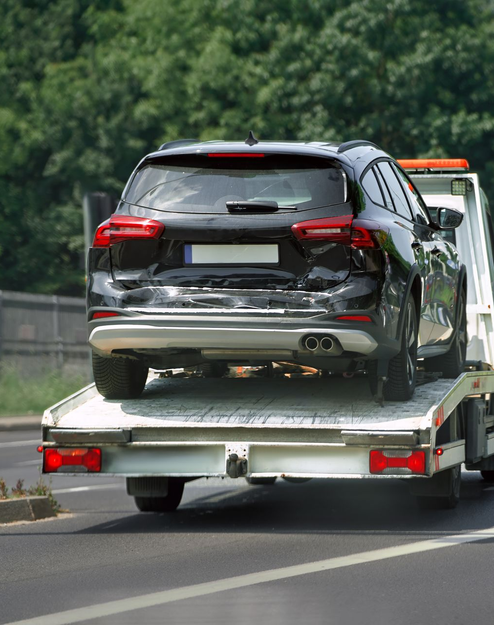 A Black Station Wagon With Rear-end — JP's Towing and Transport in Esk, QLD