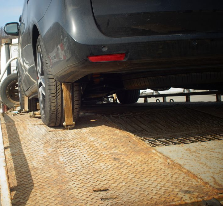 A Gray Car is Secured on a Metal Flatbed — JP's Towing and Transport in Kingsthorpe, QLD