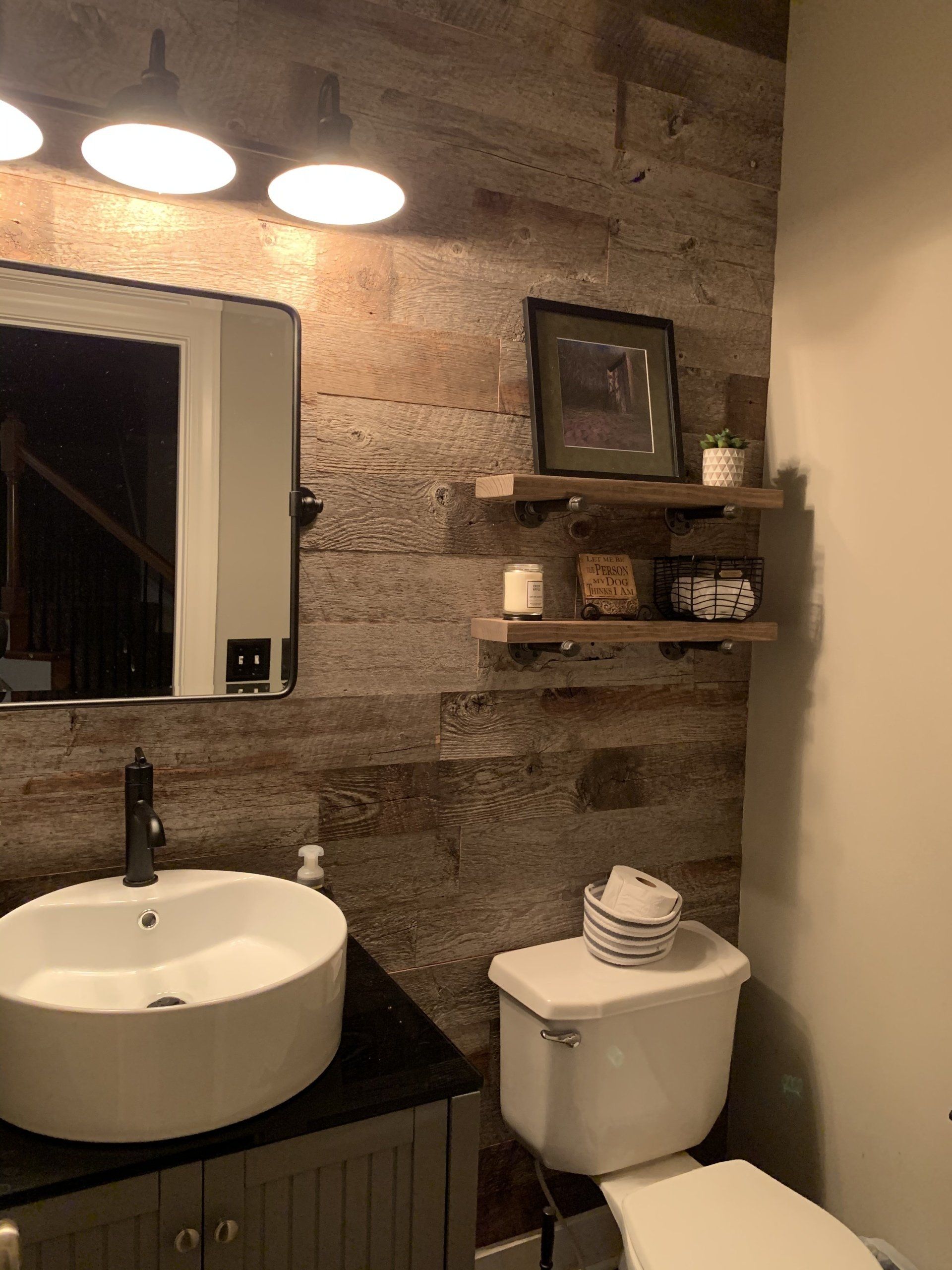 A bathroom with a sink , toilet and mirror.