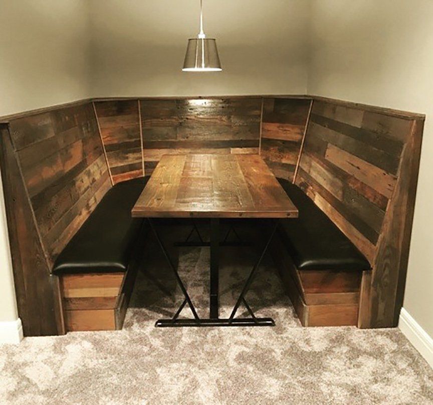 A wooden booth with a table in the middle