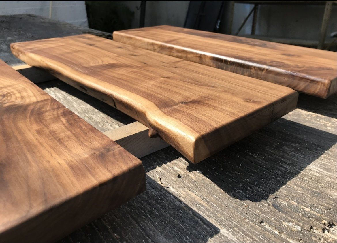 Three wooden boards are sitting on top of each other on a table.