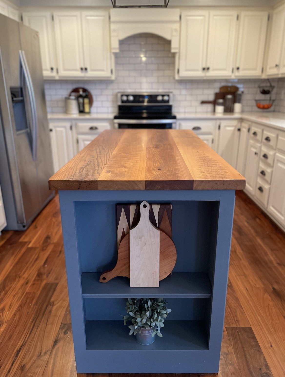 A kitchen with a large island with a wooden counter top