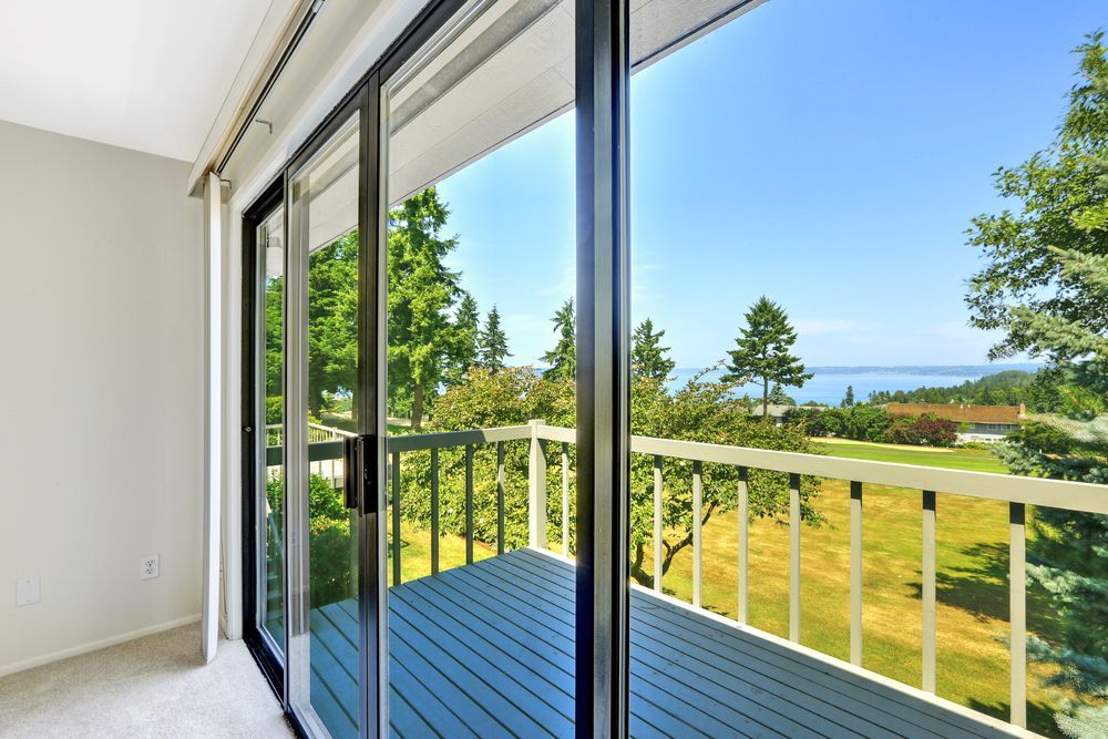 Sliding Glass Doors and Glass Window Open to a Balcony — ALUBEST Windows & Doors In Southport, QLD