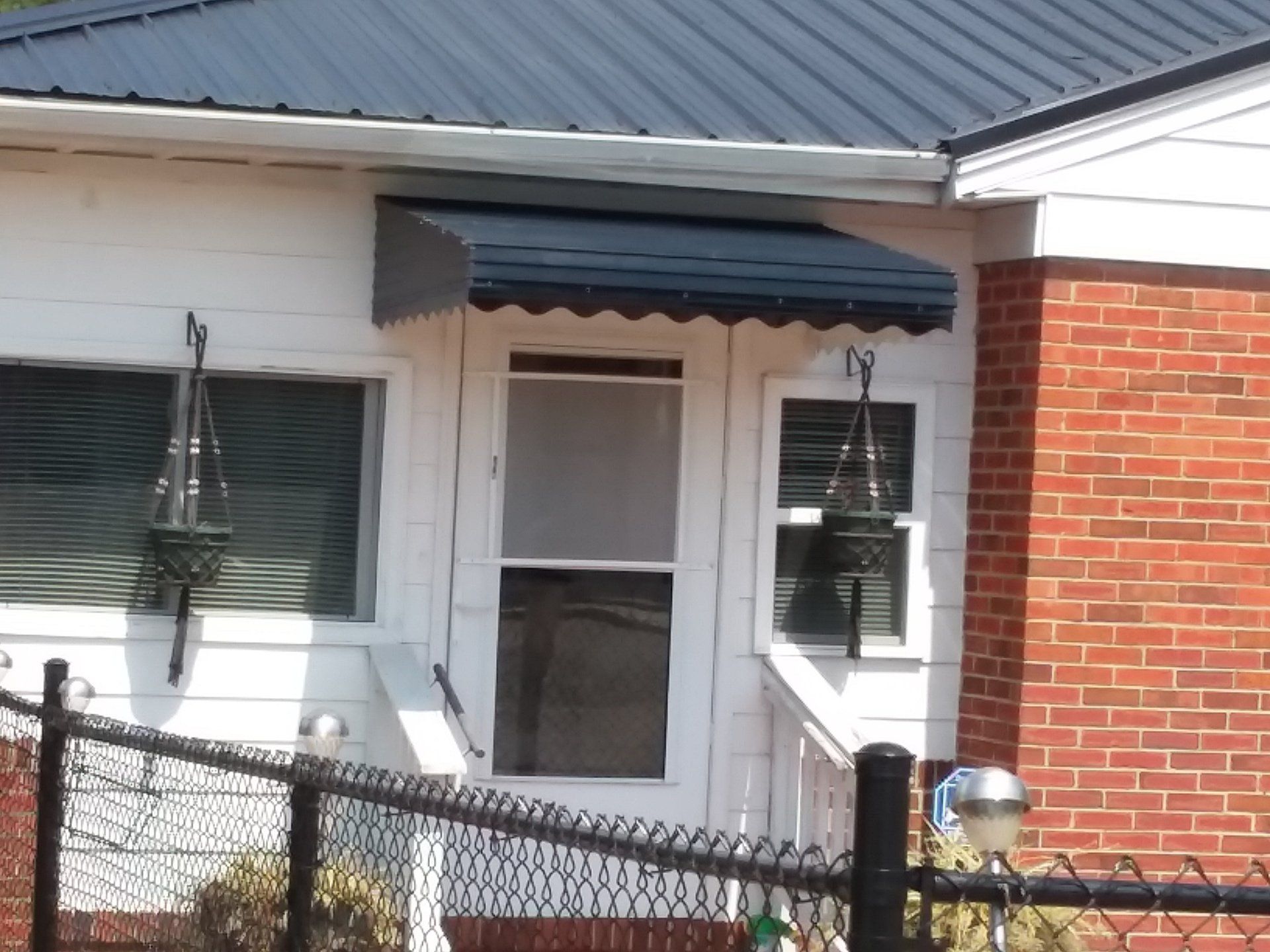 Black aluminum awning with fringe