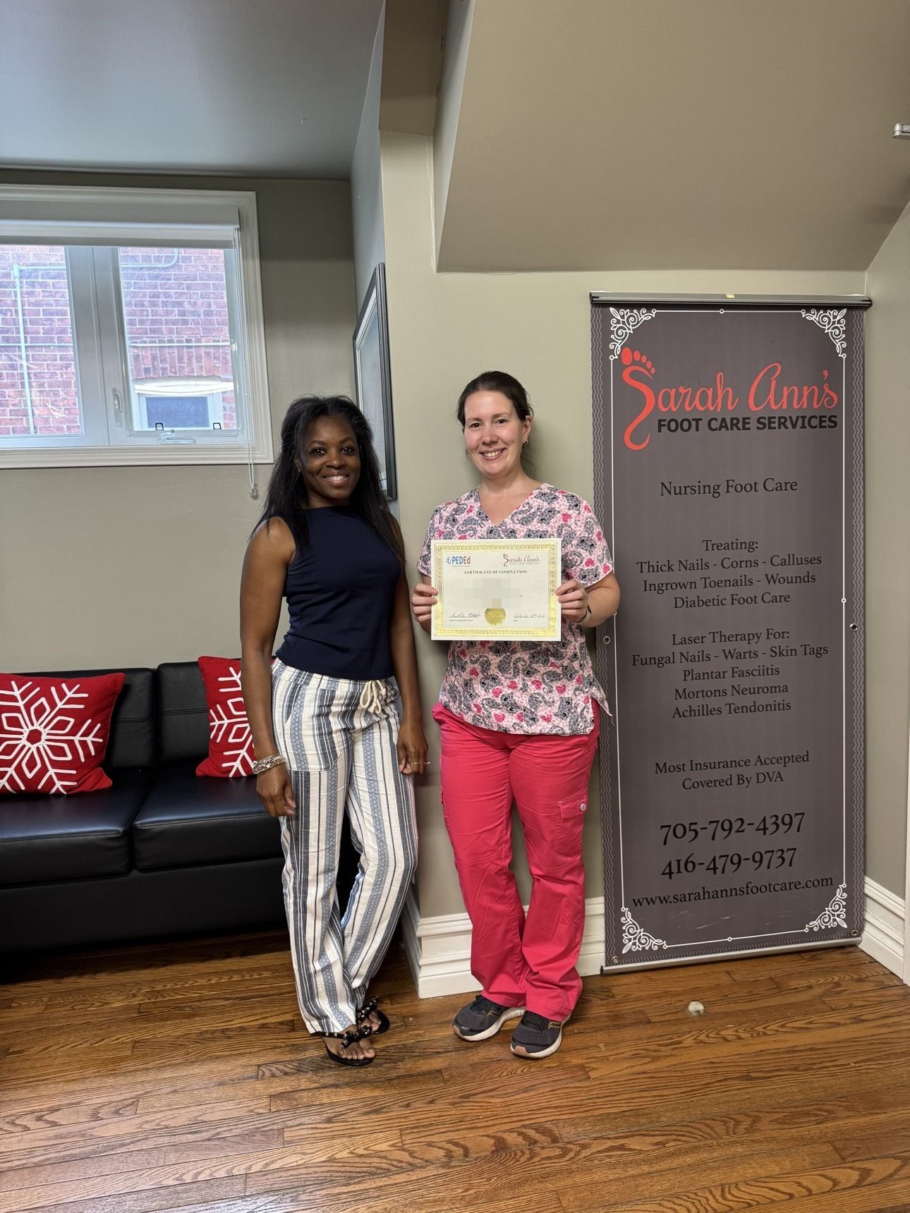 Sarah with a graduating student holding her certificate