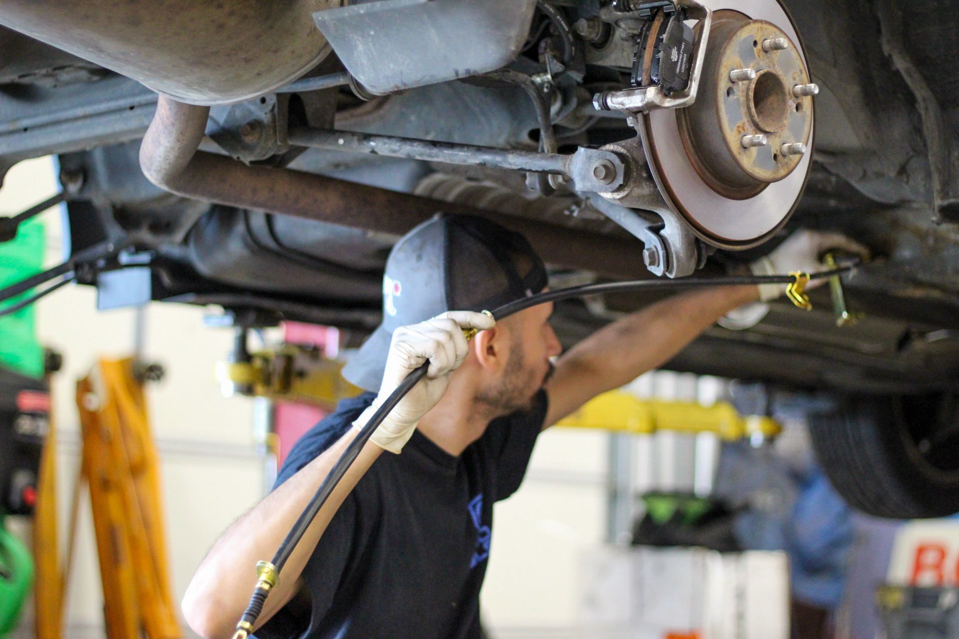 Mechanic Working On Under Chassis | Churchill Auto Care 