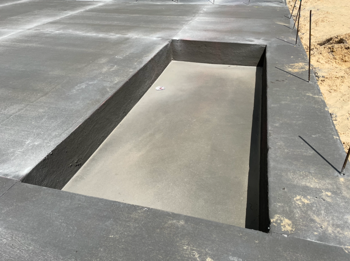 A concrete foundation with a hole in the middle of it. Project done by C1 Foundations