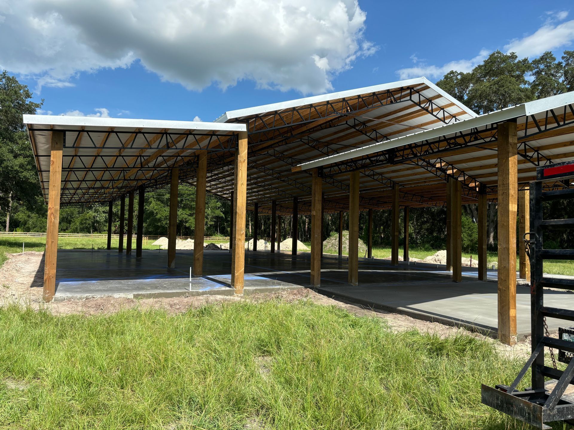 A large building is being built in the middle of a grassy field. Project done by C1 Foundations