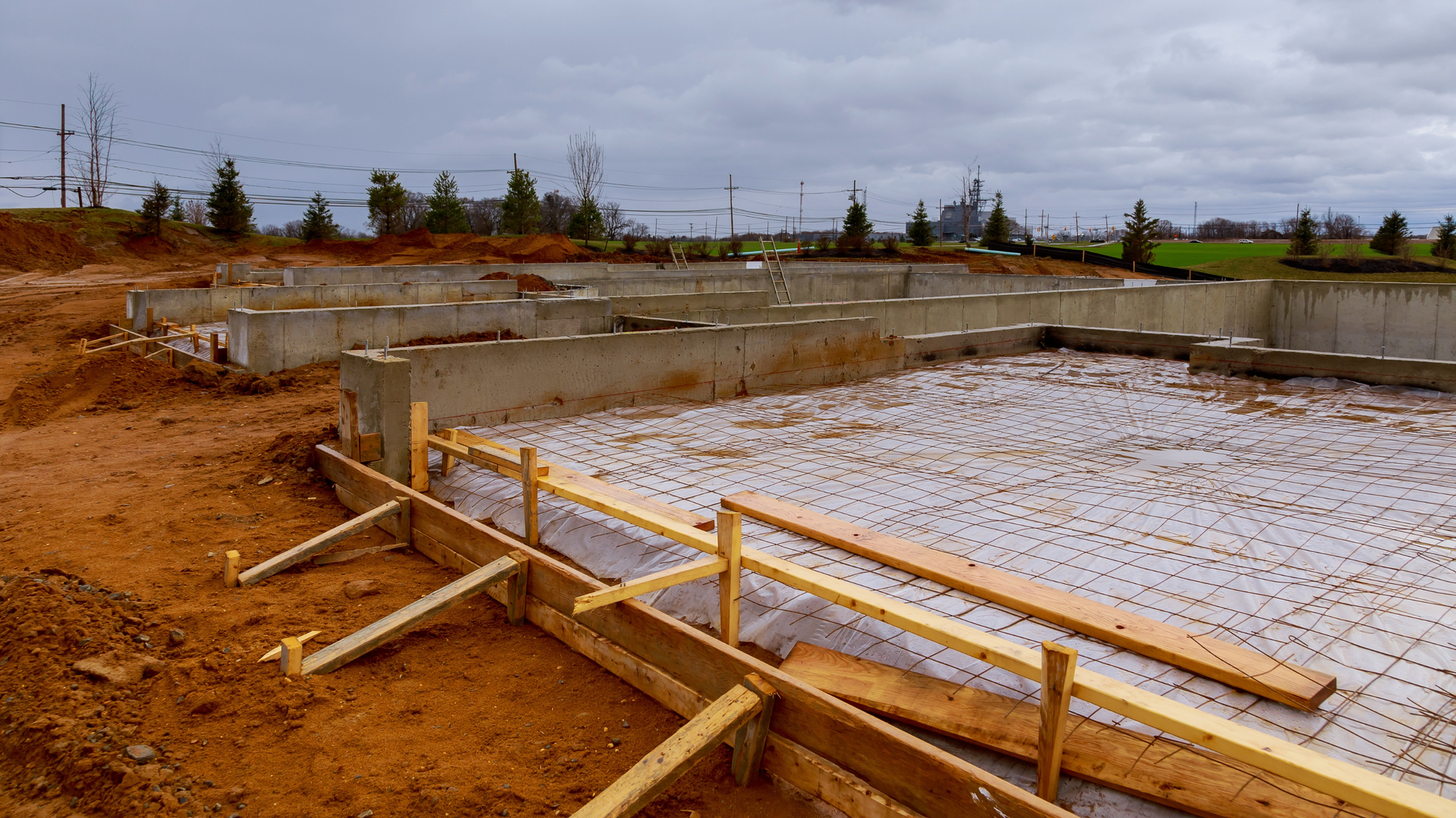 Concrete crew compacting and preparing the base before pouring in Ocala
