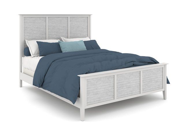 A bed with a blue comforter and pillows on a white background.